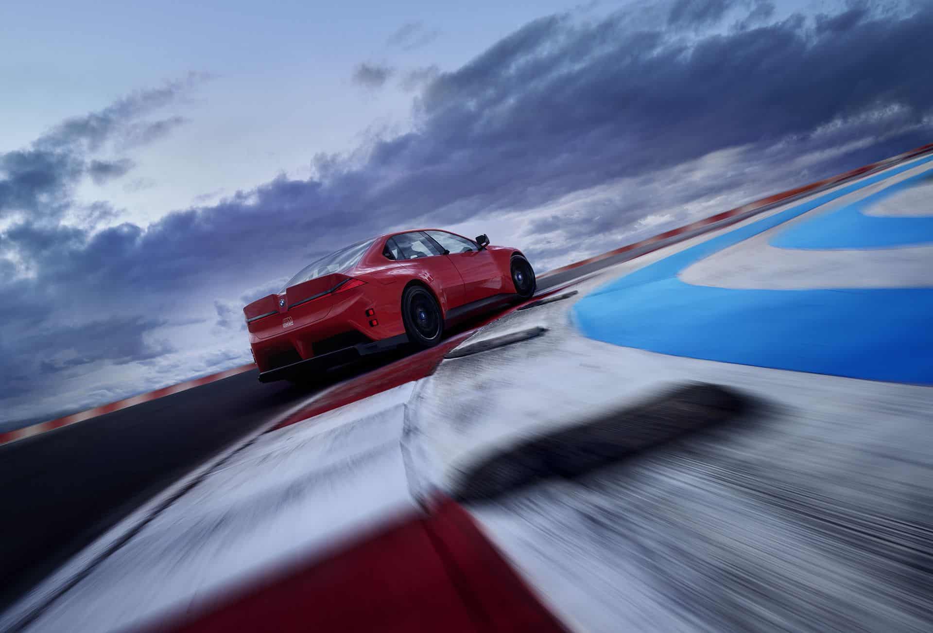 BMW M Concept Neue Klasse electric M3 cornering on a banked racetrack with motion blur