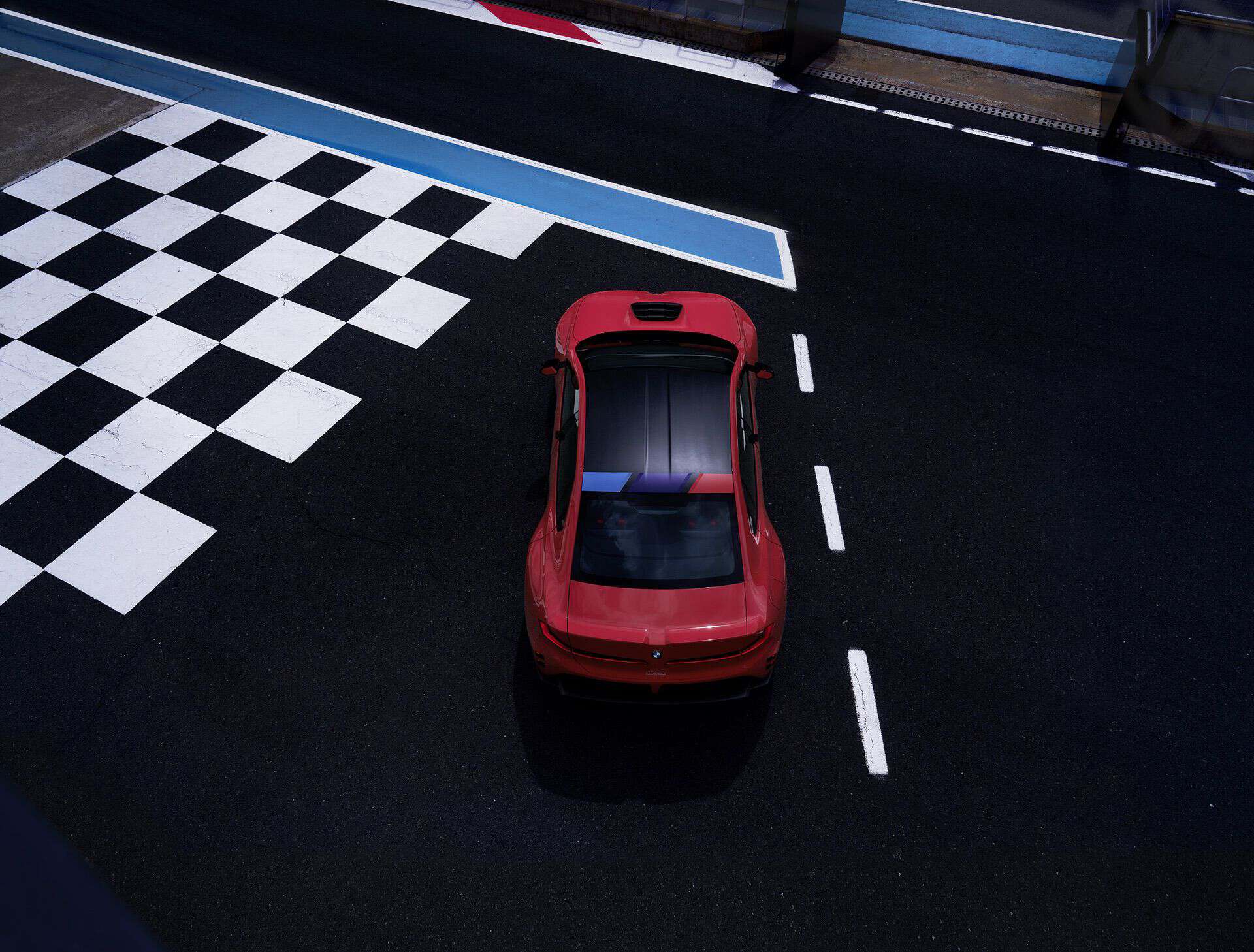BMW M Concept Neue Klasse electric M3 crossing a checkered start/finish line, high rear view