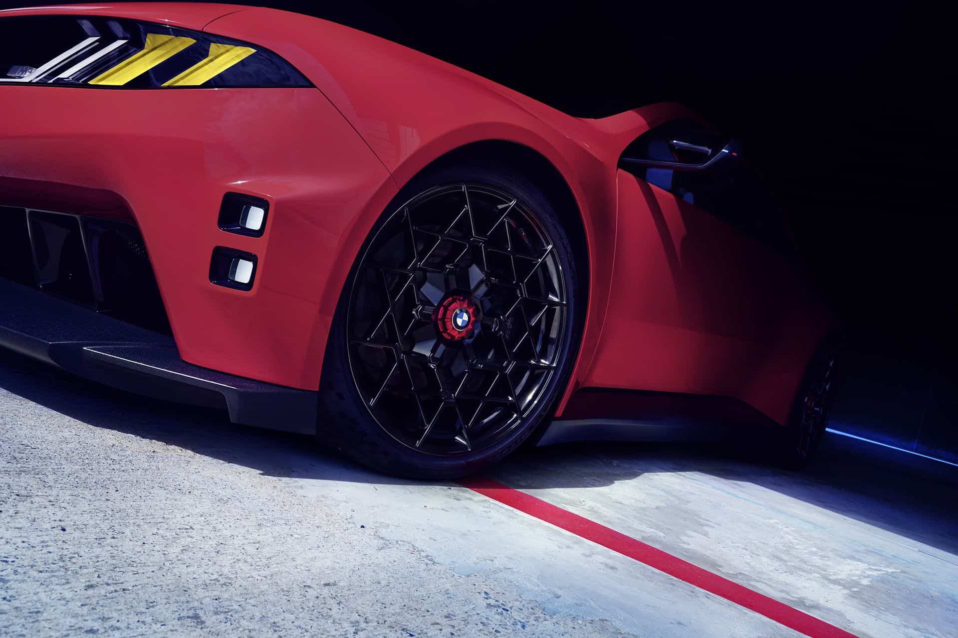 BMW M Concept Neue Klasse electric M3 front wheel: black center-lock wheel, red BMW cap, red M brake caliper
