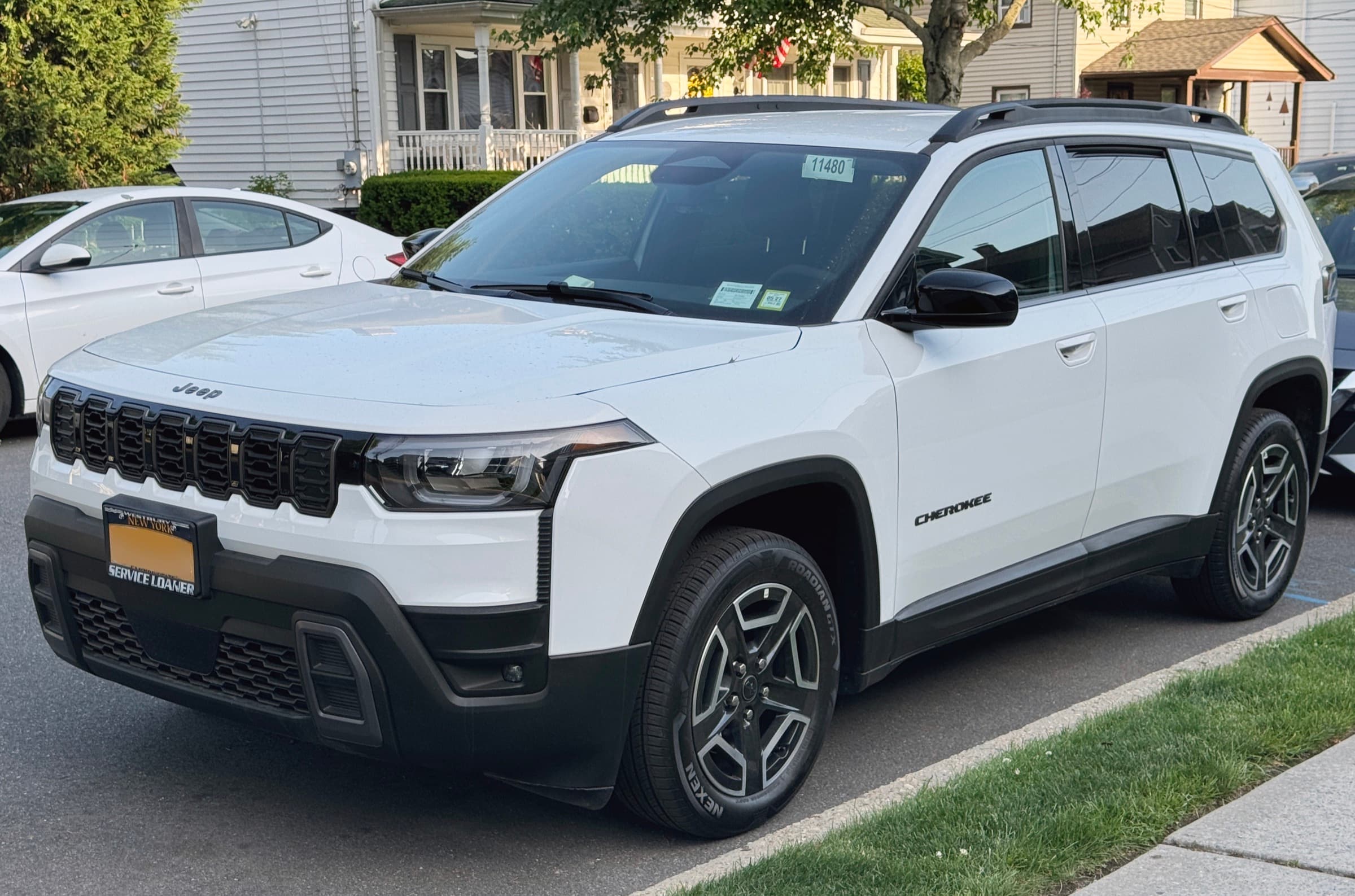 2026 Jeep Cherokee Laredo in Bright White, front three-quarter street view