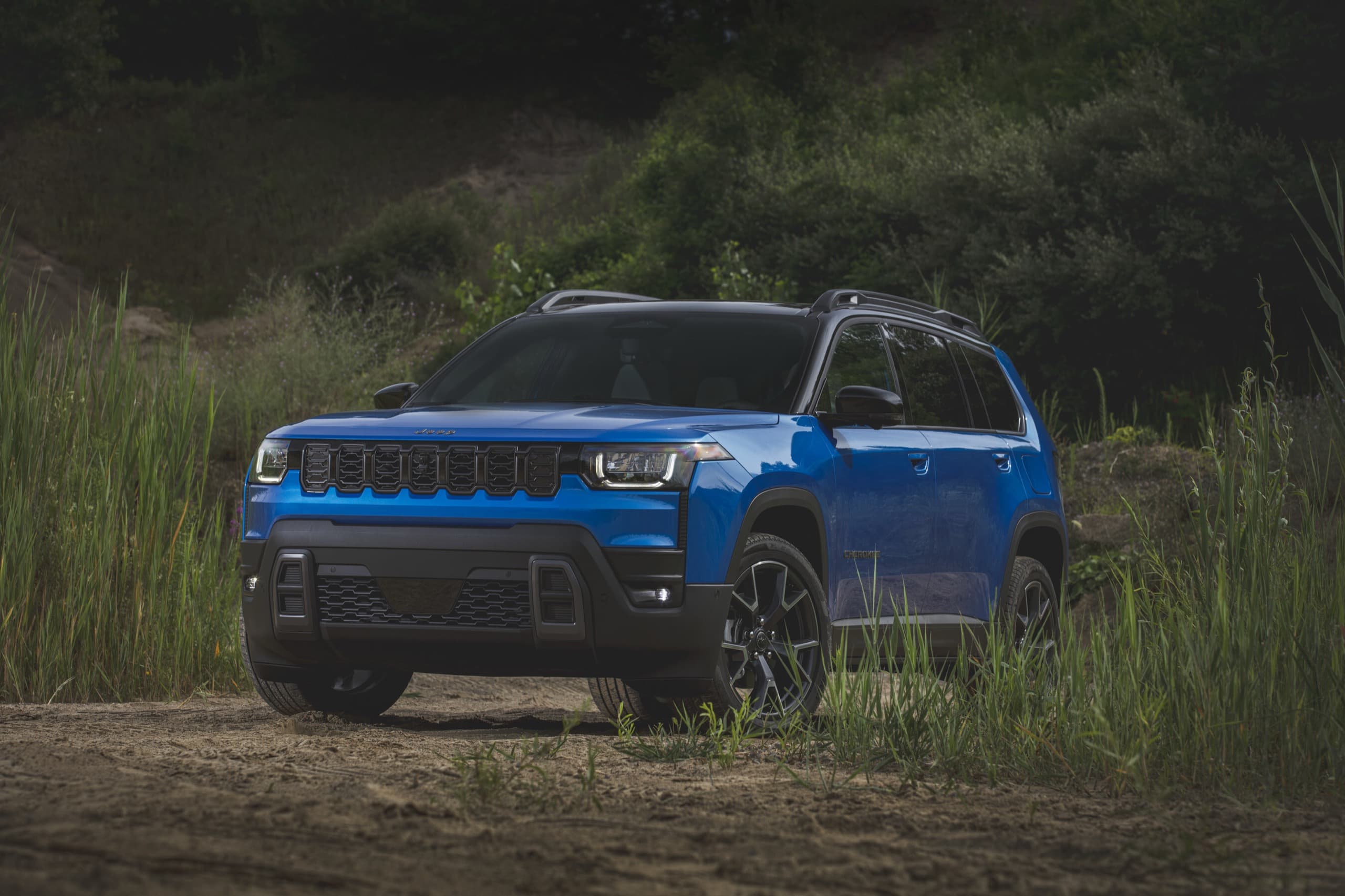 2026 Jeep Cherokee on a dirt trail, official Jeep press photo