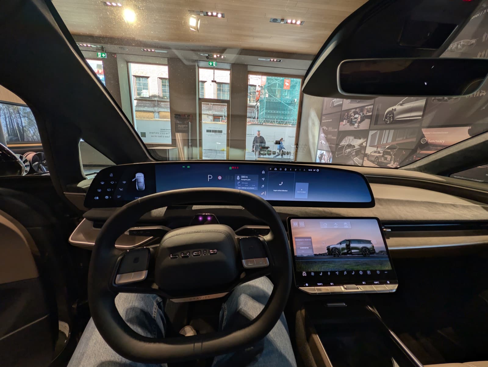 Lucid Gravity interior showing the curved display, minimalist dashboard, and front seats