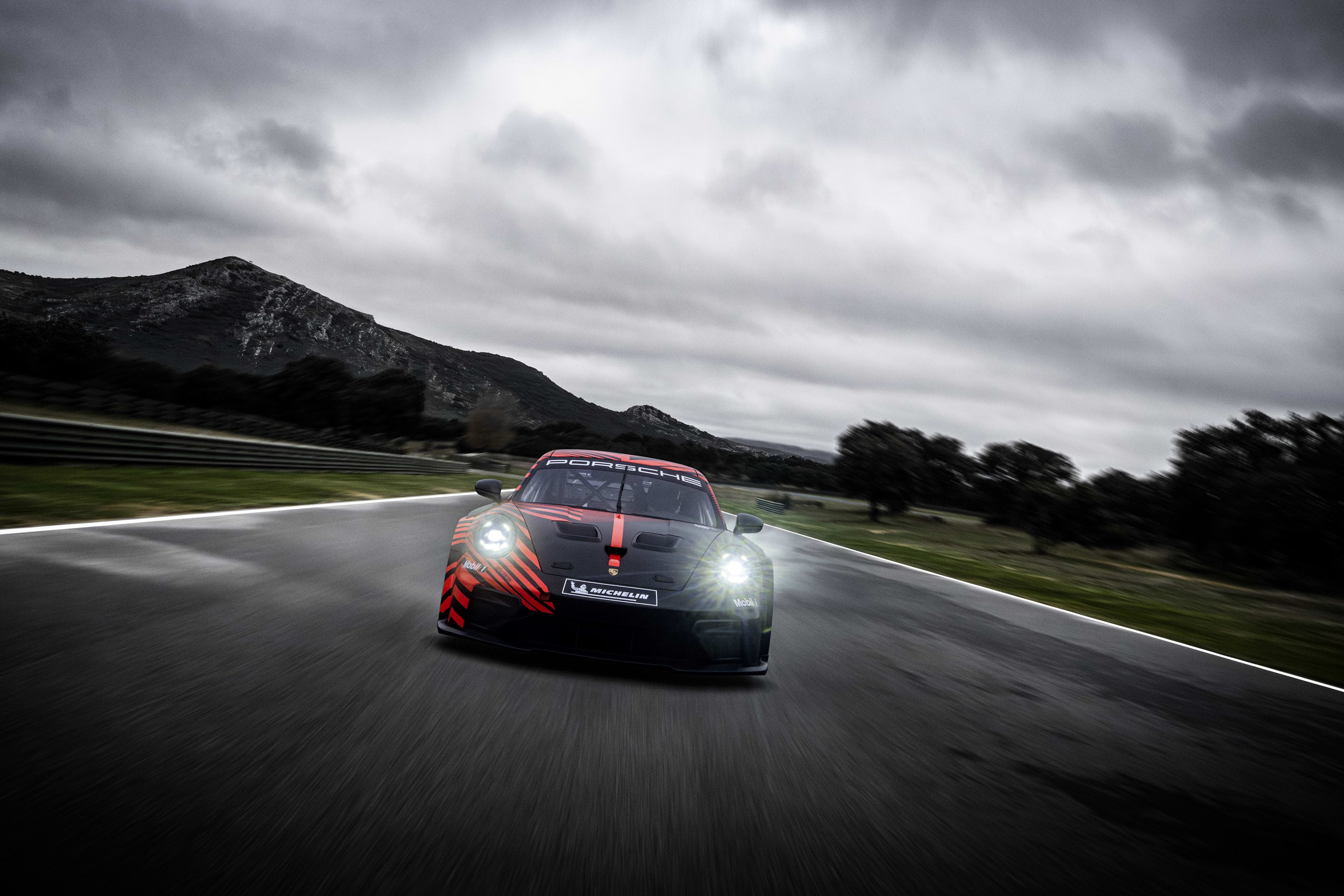 Porsche 911 GT4 R front three-quarter view with race aero and wide front track