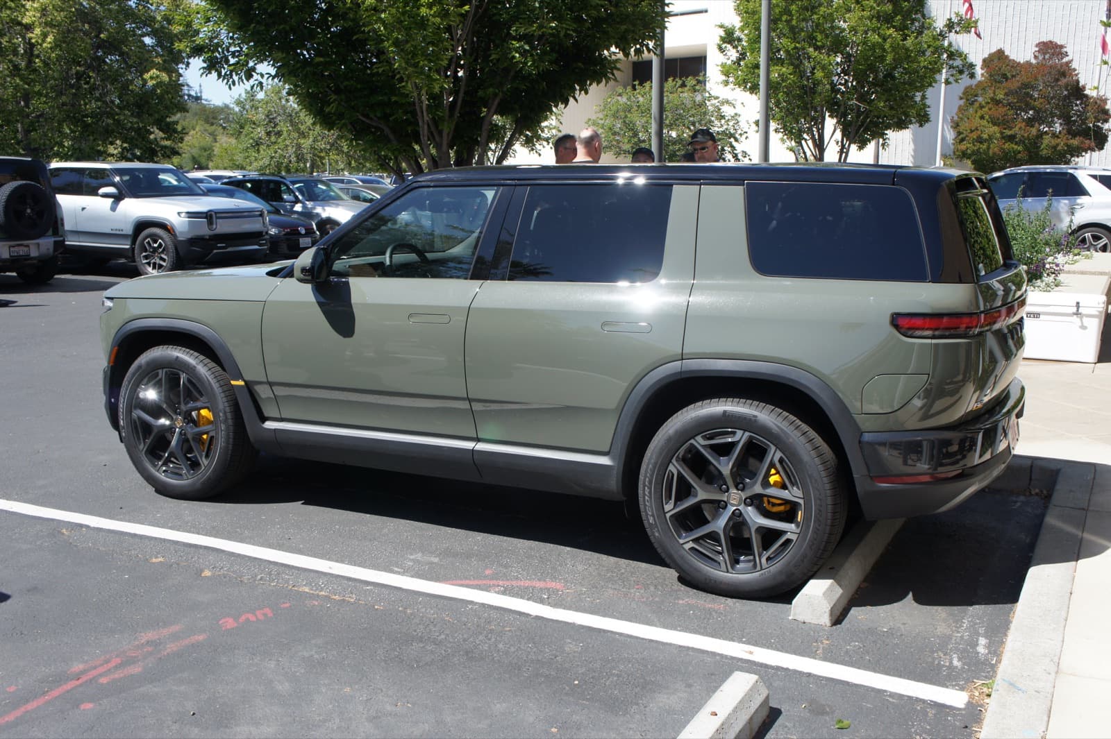 Rivian R2 electric SUV in Launch Green, side and rear three-quarter view