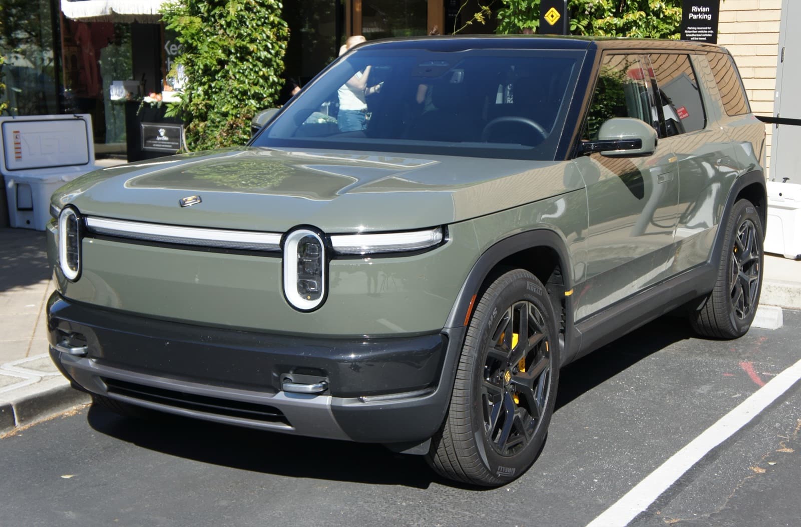 Rivian R2 electric SUV in Launch Green, front three-quarter view