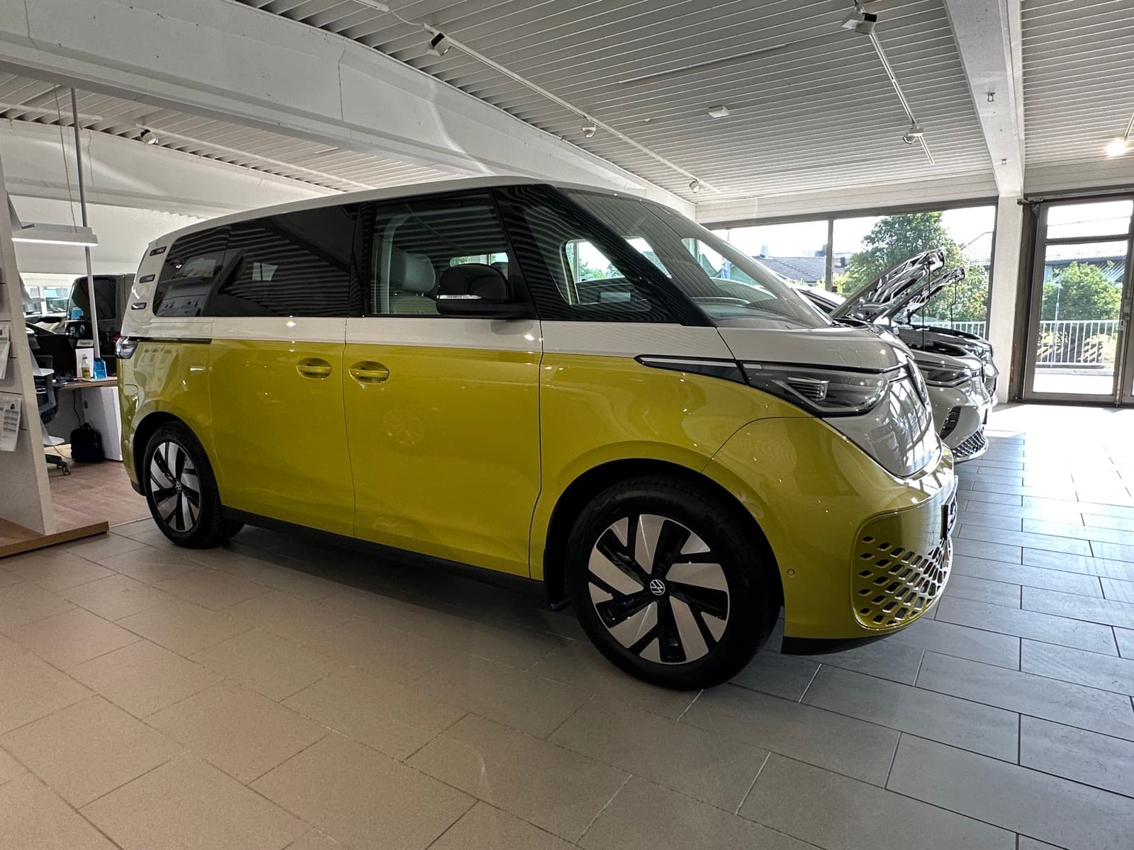 Volkswagen ID. Buzz electric van in two-tone yellow and white, front three-quarter view