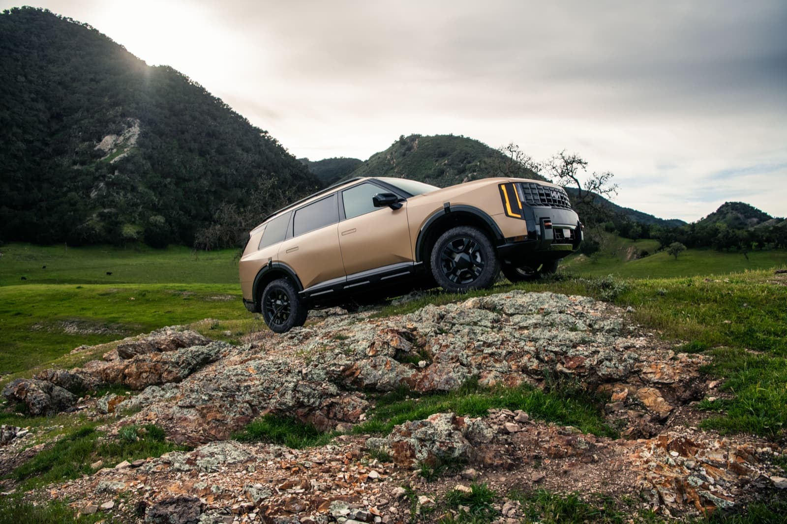 2027 Kia Telluride X-Pro climbing a rocky off-road trail