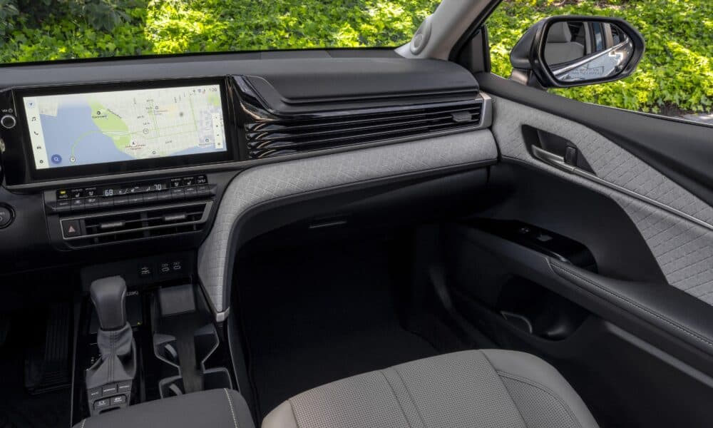 2026 Toyota Camry XLE interior in light gray, showing the dashboard and quilted door trim