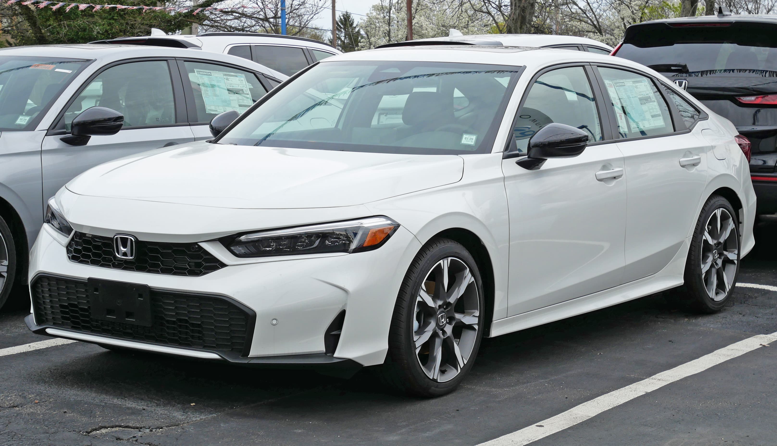 2025 Honda Civic Hybrid Sport Touring front three-quarter view, used as 2026 Civic Hybrid editorial reference